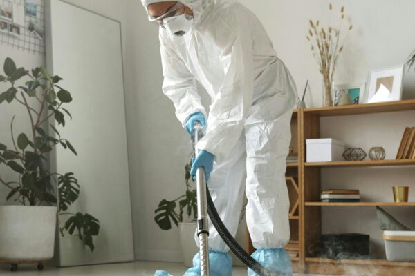 Cleaning team performing detailed deep cleaning of kitchen and bathroom surfaces